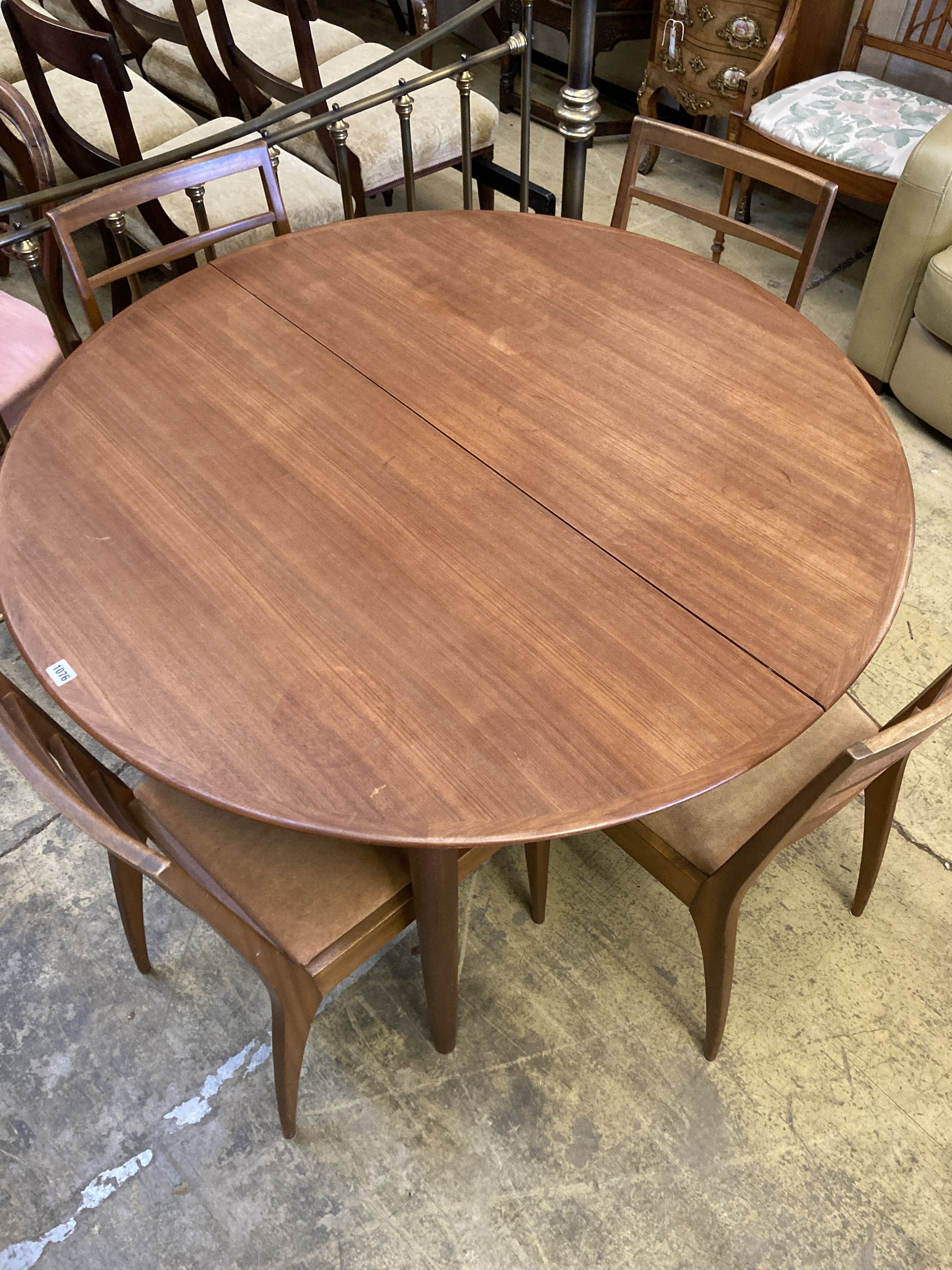 A mid century design Dryland Danish teak extending dining table, 120cm diameter, height 72cm and four chairs